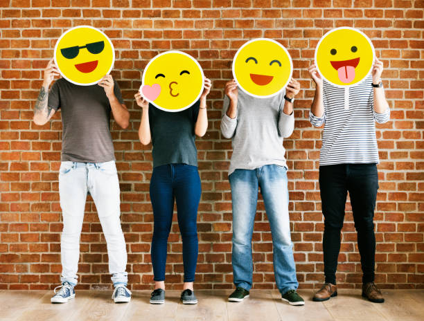 istock People holding positive emoticons 1072315482