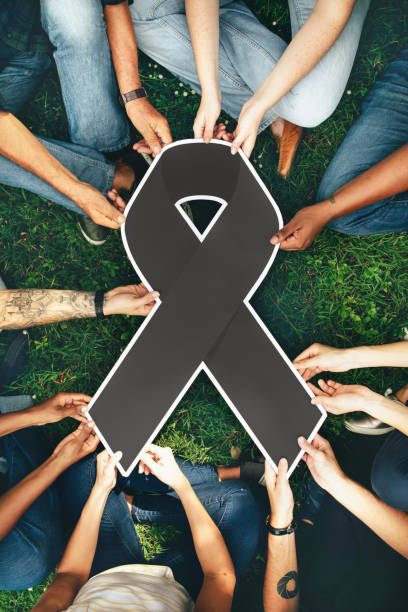 istock Group of people holding a gray colored ribbon 1072316008
