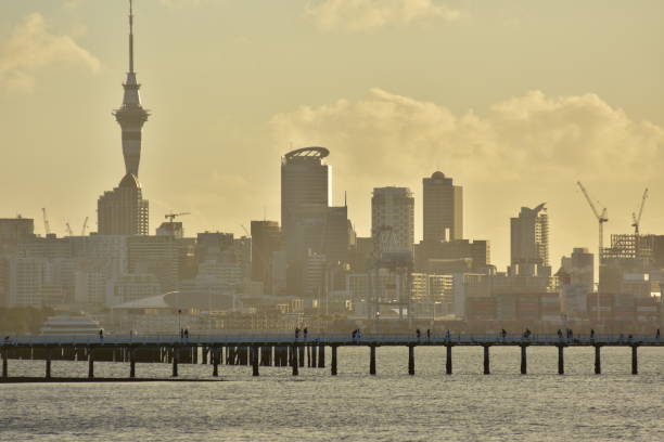istock Orakei wharf and Auckland silhouette 1072338952