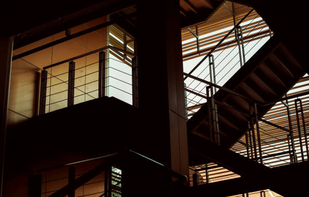 istock Building interior with stairs in the dusk 1072346898