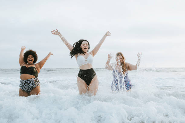 Diverse plus size women having fun in the water Diverse plus size women having fun in the water plus size photos stock pictures, royalty-free photos & images