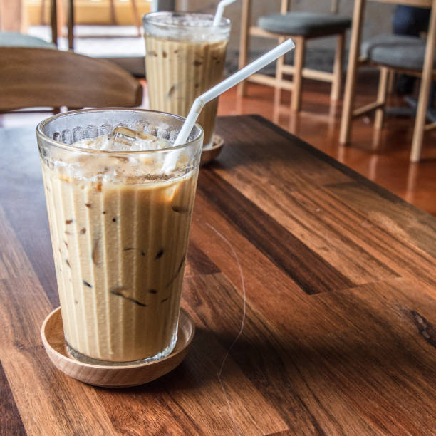 Coffee glass on the wooden floor with blur background.