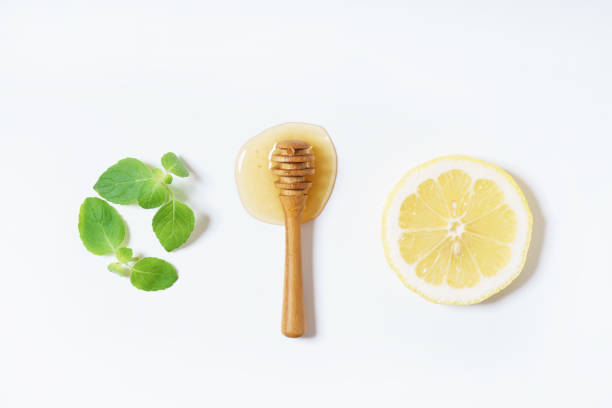 istock lemon, honey and mint leaves on white background 1072351376