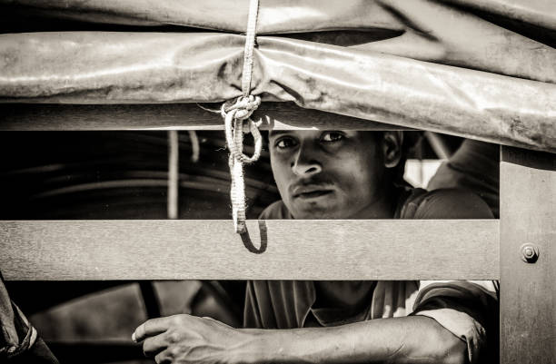 SINGAPORE - JUNE 2012: An unidentified indian construction worker looks into the camera. There are many ethnic Indian immigrant workers in Singapore