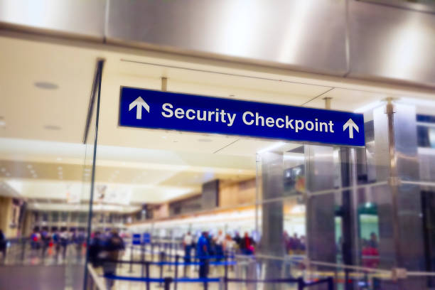 Security Checkpoint at the airport Airport Sign at the entrance of the security checkpoint with People waiting in line. security barrier photos stock pictures, royalty-free photos & images