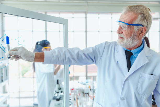 istock Science teacher men working with transparent glass board chemicals in lab 1072361492