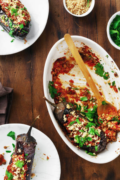 Vegetarian baked stuffed eggplant lentils tomatoes nuts top view Healthy vegetarian food