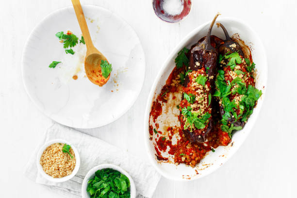 Vegetarian baked stuffed eggplant lentils tomatoes nuts top view Healthy vegetarian food