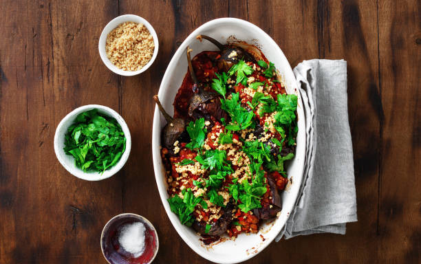 Vegetarian baked stuffed eggplant lentils tomatoes nuts top view Healthy vegetarian food