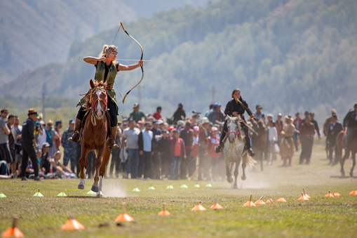 Lake Issyk-Kul, Kyrgyzstan, 6th September 2018: Woman practicing archery on horseback game