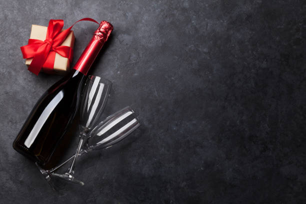 istock Christmas card with champagne and gift 1072366356