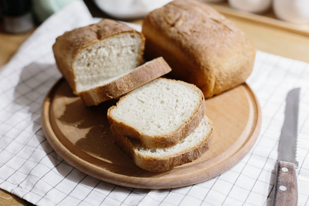 istock Homemade freshly baked bread on the kitchen table. 1072369436