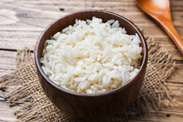 istock White boiled rice in a wooden bowl. Rustic style. 1072369860