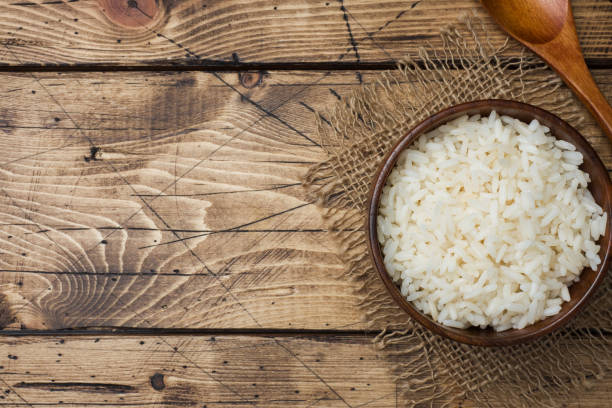 istock White boiled rice in a wooden bowl. Rustic style. Copy space 1072371688
