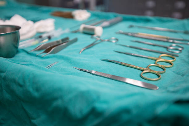 istock surgical instruments and tools including scalpels, forceps and tweezers arranged on a table for a surgery and vivisection . 1072374800