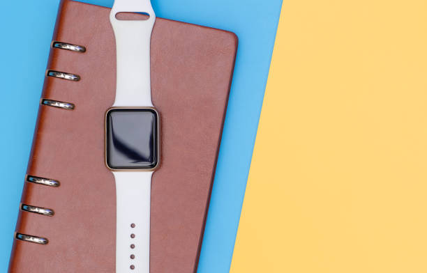 istock Smart watch on notebook for organize concept with blue yellow 1072375182