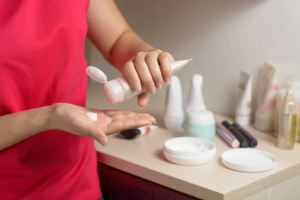 istock Hand care. Woman applying cream on her hands 1072376894