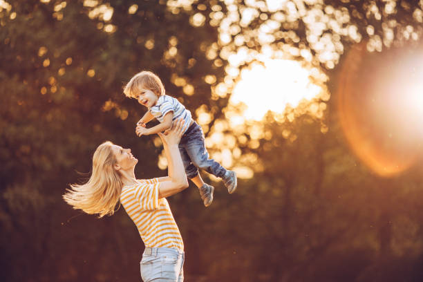 istock Playful mother having fun with her small boy at the park. 1072378898