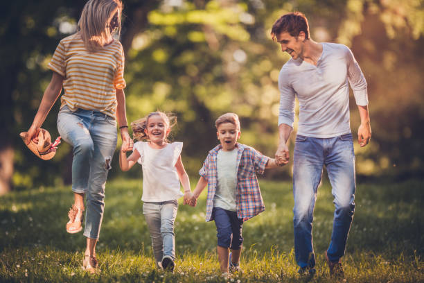 istock Carefree family having fun while running in the park. 1072379094
