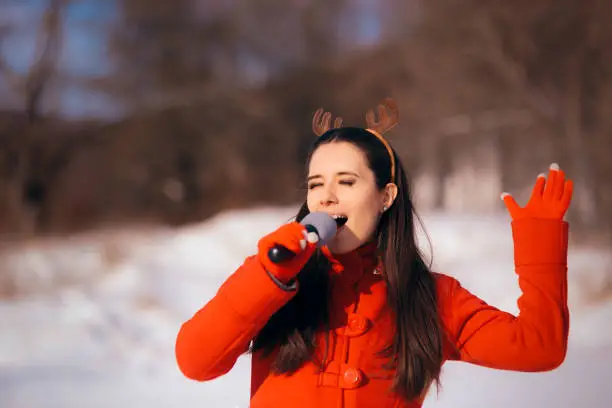 Photo of Christmas Girl Singing Carols Outdoors in Wintertime