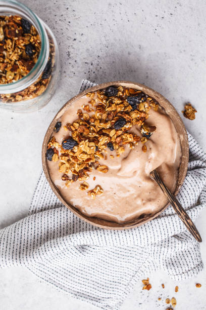 istock Chocolate smoothie bowl with granola in a coconut bowl. 1072379510