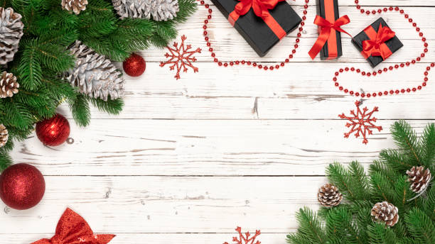 istock Christmas background with new year decor, gift box, pine cone, fir tree branches, star on a old white wooden background 1072380820
