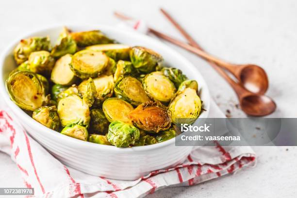 Baked Brussels Sprouts On A White Plate Stock Photo - Download Image Now - Brussels Sprout, Roasted, Cut Out