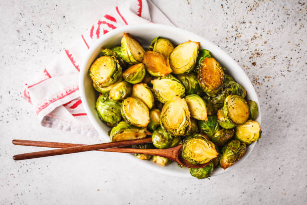 istock Baked brussels sprouts on a white plate, copy space, top view. 1072383476