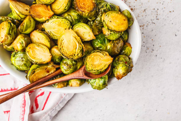 istock Baked brussels sprouts on a white plate, copy space, top view. 1072383606