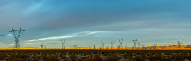 Transmission Pylons on Desert Landscape Panorama