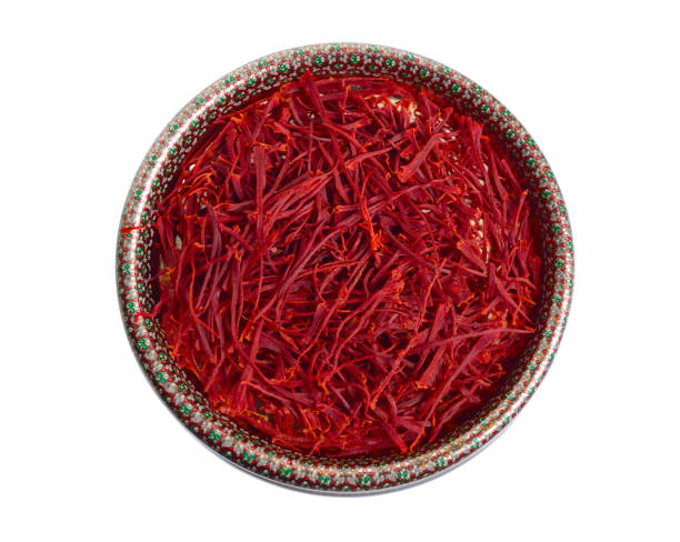 istock Delicate saffron threads, plucked from crocus flowers and dried. In the ethnic box. Isolated on white background 1072384144