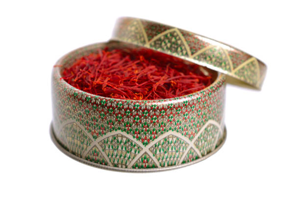 istock Delicate saffron threads, plucked from crocus flowers and dried. In the ethnic box. Isolated on white background 1072384776