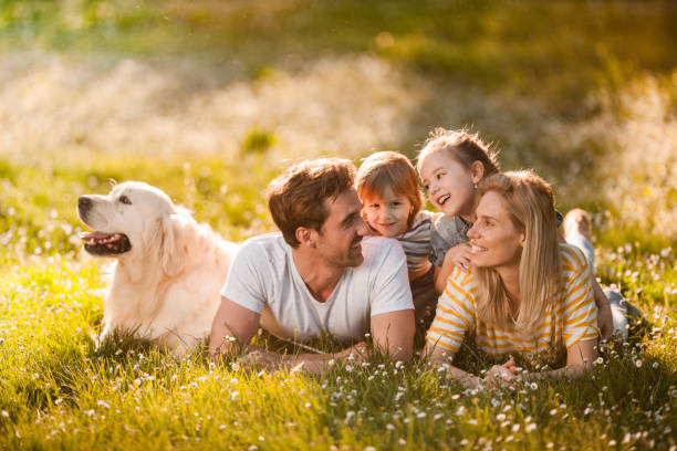 istock Relaxed family talking while enjoying with a dog in nature. 1072385300