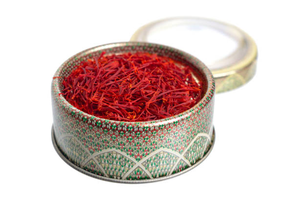istock Delicate saffron threads, plucked from crocus flowers and dried. In the ethnic box. Isolated on white background 1072385682