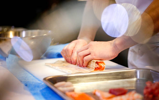 istock chef hands preparing japanese food, chef making sushi, Preparing Sushi roll 1072393454