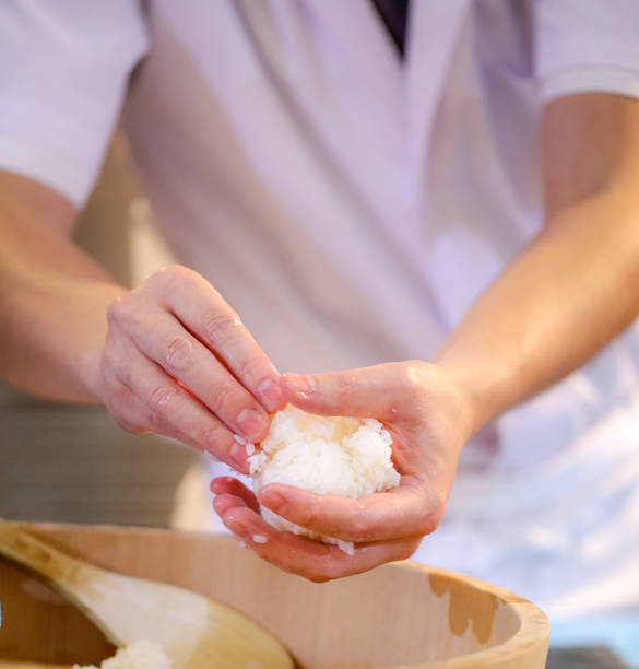 istock chef hands preparing japanese food, chef making sushi, Preparing Sushi roll 1072393474