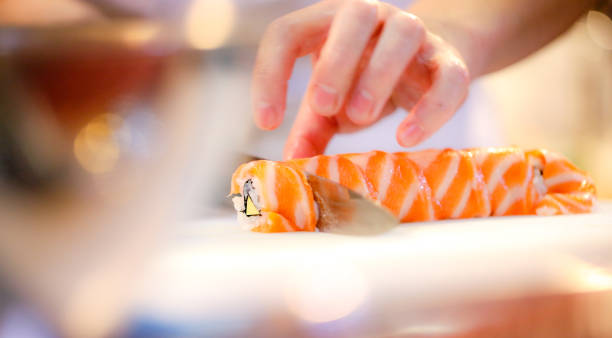 istock chef hands preparing japanese food, chef making sushi, Preparing Sushi roll 1072393516