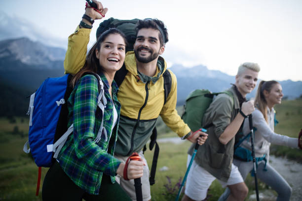 istock Backpackers happy young couple hiking with sticks 1072397828