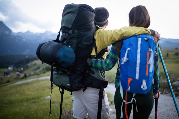 istock Couple - active hikers hiking enjoying view looking at mountain forest landscape 1072397838