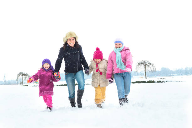 istock Cute family having fun in the snow 1072402432
