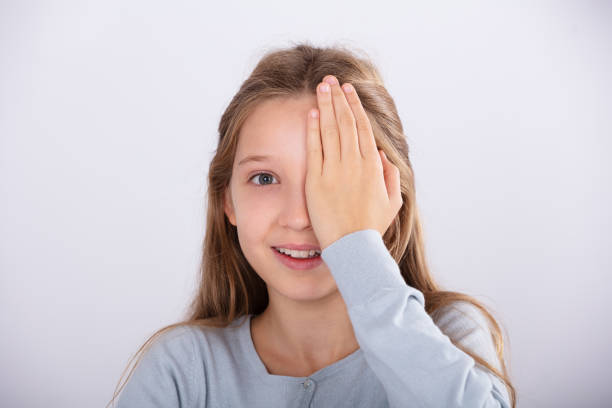 istock Girl Checking Her Eyesight 1072406500