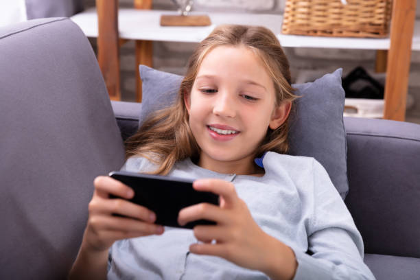 istock Girl Lying On Sofa Using Mobile Phone 1072406798