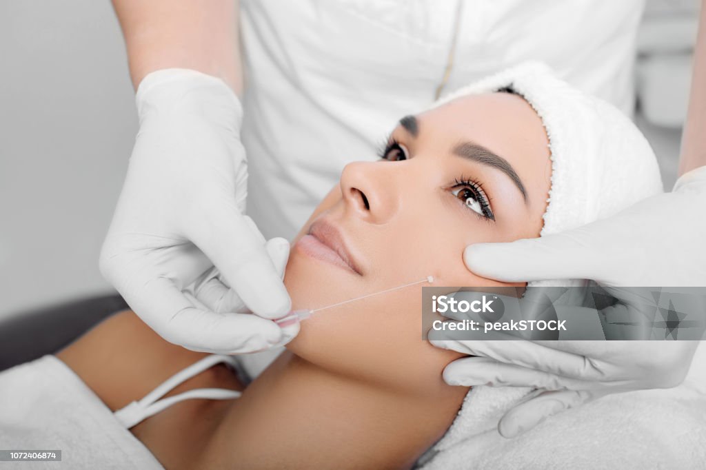 Aesthetic face surgery,cosmetic technique, mesothreads lifting and contouring face cropped woman face getting facelift , procedure mesothreads lifting skin Thread - Sewing Item Stock Photo