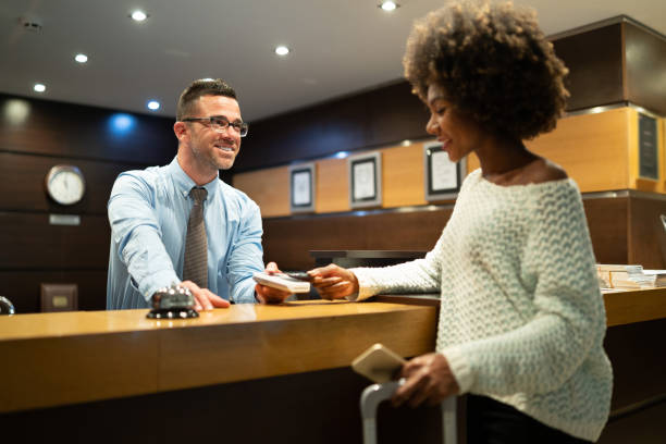 istock Businesswoman paying at hotel reception 1072406894