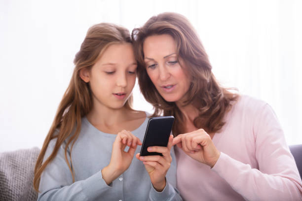 istock Mother And Daughter Using Cellphone 1072406930