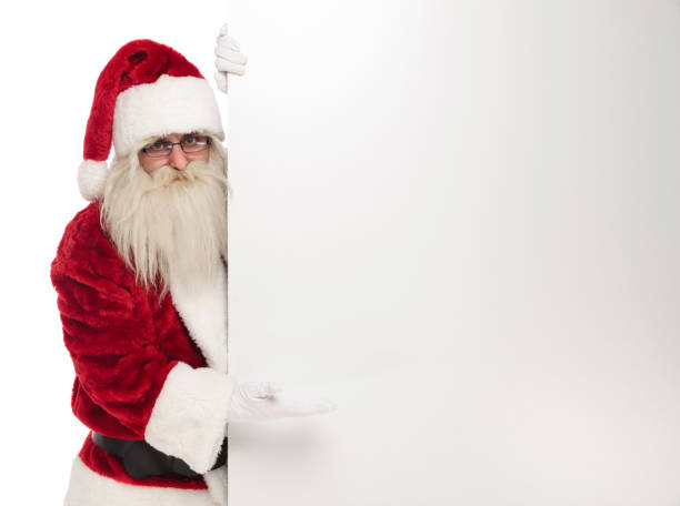 istock happy santa claus holds empty board to side 1072411658