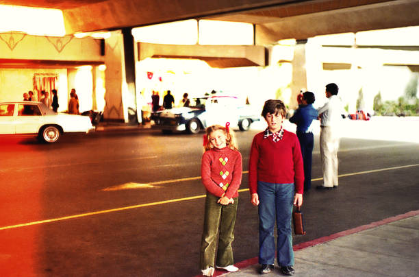 Vintage kids standing on the street Vintage image of a boy and a girl  standing on the street. 1980 stock pictures, royalty-free photos & images