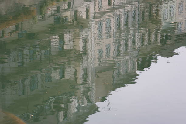 istock houses in the river reflecting 1072414376