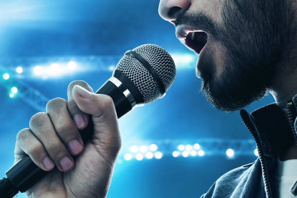 istock Close up singer singing with microphone 1072414466
