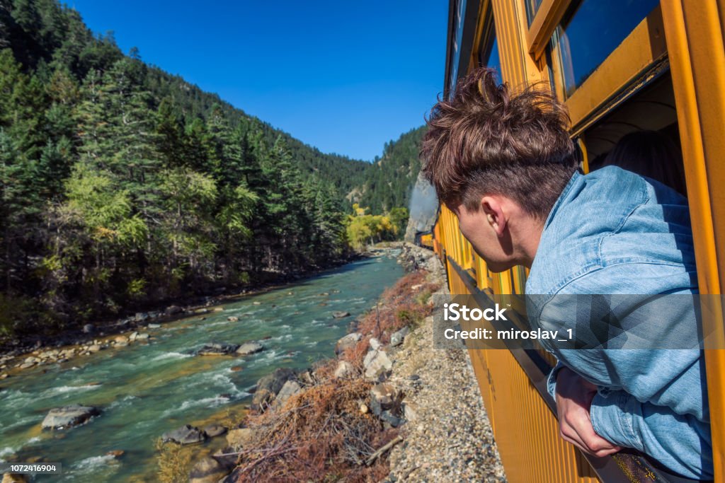 Young Man Looking Out Of Train Window Stock Photo - Download Image